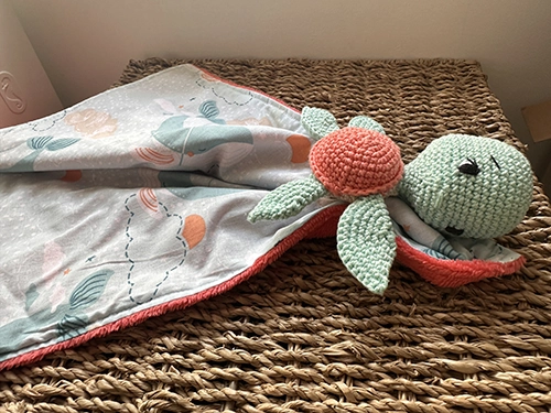Doudou plat tortue au crochet vert d'eau et corail avec tissu imprimé pastel et tissu Minky ultra doux pour bébé.