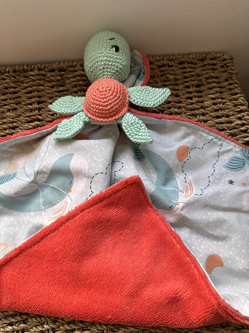 Doudou plat tortue au crochet vert d'eau et corail avec tissu imprimé pastel et tissu Minky ultra doux pour bébé.